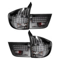 A pair of aftermarket car tail lights with smoked lenses and integrated LED light bars, shown against a plain white background.