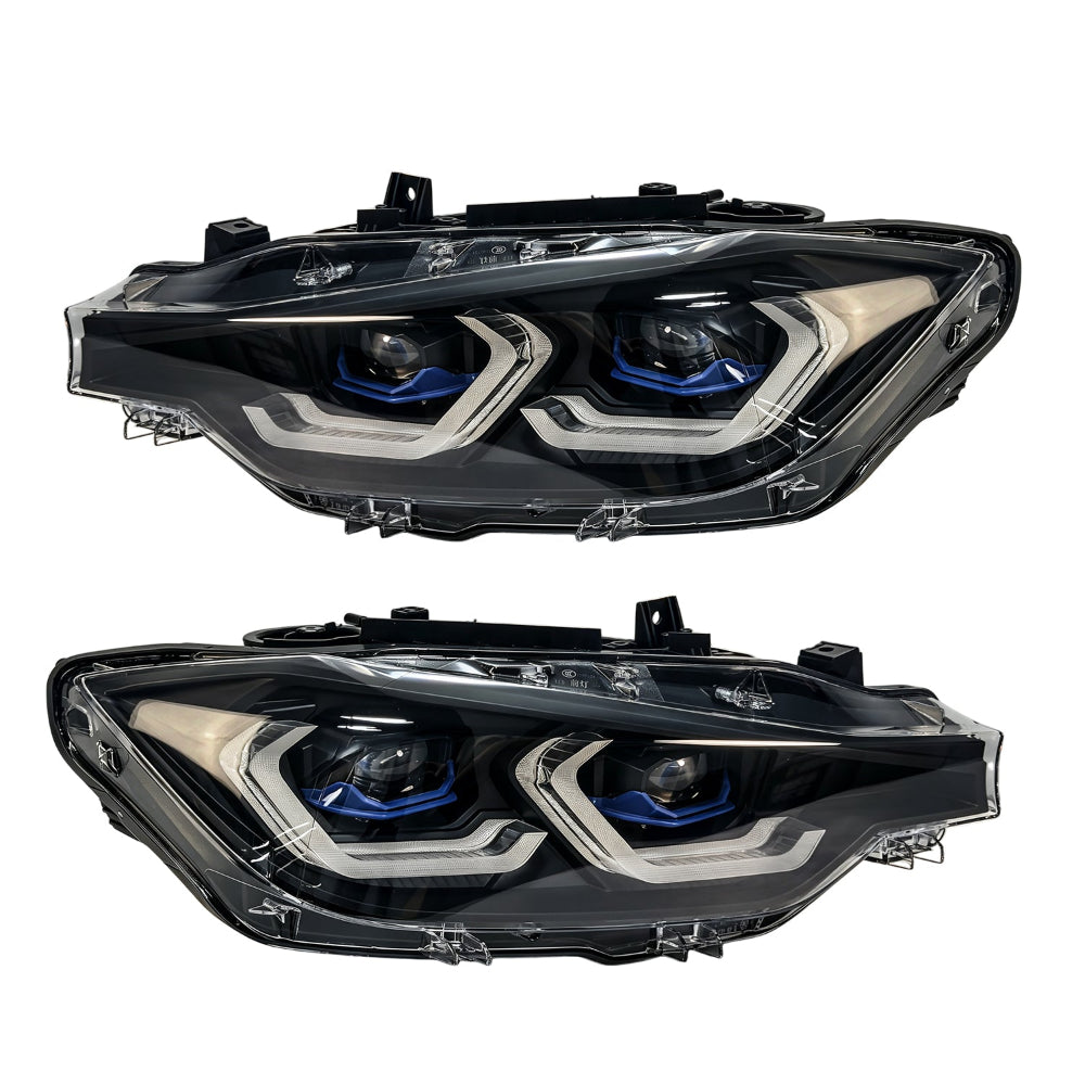 A pair of modern car headlight assemblies shown against a plain white background. The headlight housings are black with silver chrome accents and blue LED light rings around the projector lenses.